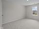 Neutral bedroom featuring a large window and neutral walls at 10543 Banyan Wood Ct, Indianapolis, IN 46239