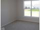 Bedroom featuring neutral carpet, base molding, and a large window at 10543 Banyan Wood Ct, Indianapolis, IN 46239