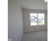 Bright bedroom featuring a large window with neighborhood views and neutral carpeting at 10543 Banyan Wood Ct, Indianapolis, IN 46239