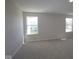 Bright bedroom featuring neutral carpet and two large windows at 10543 Banyan Wood Ct, Indianapolis, IN 46239
