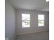 Bedroom featuring neutral carpet and two bright windows at 10543 Banyan Wood Ct, Indianapolis, IN 46239