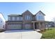 Inviting two-story home featuring a three-car garage, brick accents, and a covered front porch at 10543 Banyan Wood Ct, Indianapolis, IN 46239