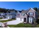 Beautiful home showcasing a well-manicured lawn and spacious three-car garage at 10543 Banyan Wood Ct, Indianapolis, IN 46239