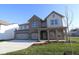 Beautiful two-story home with three-car garage, a welcoming covered entrance, and well-maintained landscaping at 10543 Banyan Wood Ct, Indianapolis, IN 46239