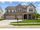 Charming two-story home with a brick facade, three-car garage, and well-manicured lawn at 10543 Banyan Wood Ct, Indianapolis, IN 46239