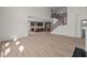 Open-concept living area showcasing hardwood floors, a staircase, and a kitchen view at 10543 Banyan Wood Ct, Indianapolis, IN 46239