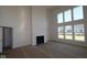 Bright living room with soaring ceilings, a cozy fireplace, and large windows offering abundant natural light at 10543 Banyan Wood Ct, Indianapolis, IN 46239