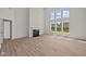 Bright living room boasts large windows, fireplace, and hardwood floors at 10543 Banyan Wood Ct, Indianapolis, IN 46239