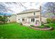 Well-maintained backyard with a deck, lush lawn, and mature landscaping at 12507 Doe Ln, Indianapolis, IN 46236
