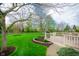 Backyard features a wooden deck overlooking the manicured lawn at 12507 Doe Ln, Indianapolis, IN 46236