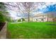 Green backyard features manicured lawn and patio space at 12507 Doe Ln, Indianapolis, IN 46236
