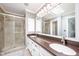 Modern bathroom features double sinks, a large mirror, and a walk-in shower at 12507 Doe Ln, Indianapolis, IN 46236