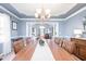 Elegant dining room featuring a decorative ceiling, chandelier, and large wooden table at 12507 Doe Ln, Indianapolis, IN 46236