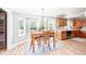 Bright dining room area features a wooden table set, adjacent to the kitchen and a bay window at 12507 Doe Ln, Indianapolis, IN 46236