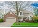 Charming two-story brick home featuring a manicured front lawn and attached two car garage at 12507 Doe Ln, Indianapolis, IN 46236