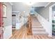 Spacious foyer featuring hardwood floors, staircase, and decorative wainscoting at 12507 Doe Ln, Indianapolis, IN 46236