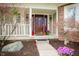 Inviting front porch with colorful flowers and stylish decor creating a warm entrance at 12507 Doe Ln, Indianapolis, IN 46236