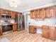 Well-lit kitchen with wooden cabinets, stainless steel appliances, and laminate wood flooring at 12507 Doe Ln, Indianapolis, IN 46236
