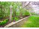Landscaping features vibrant spring blooms and stacked stone wall at 12507 Doe Ln, Indianapolis, IN 46236