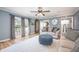 Open-concept living room with sliding glass doors to the deck and comfortable seating at 12507 Doe Ln, Indianapolis, IN 46236