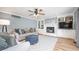 Cozy living room with built-in bookshelves, fireplace, soft sofa, and a ceiling fan at 12507 Doe Ln, Indianapolis, IN 46236