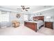 Spacious primary bedroom features a large wooden bed, accent chair, and large windows at 12507 Doe Ln, Indianapolis, IN 46236