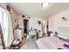 Bedroom featuring pink walls, carpeted floors, and natural light from window at 12552 Majestic Way, Fishers, IN 46037