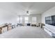 Large bonus room with neutral carpeting, ample natural light and a ceiling fan, great for recreation or hobbies at 12552 Majestic Way, Fishers, IN 46037