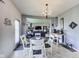 Bright dining area featuring chandelier lighting and seamless flow to the living room, perfect for entertaining at 12552 Majestic Way, Fishers, IN 46037
