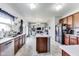 Bright, open kitchen with an island, stainless steel appliances, and open access to the living area at 12552 Majestic Way, Fishers, IN 46037