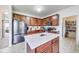 Spacious kitchen featuring a central island, stainless steel refrigerator, and ample cabinet space at 12552 Majestic Way, Fishers, IN 46037