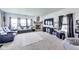 Inviting living room features plush seating, a stone fireplace, and large windows for ample natural light at 12552 Majestic Way, Fishers, IN 46037
