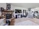 Cozy living room with a stone fireplace, large TV, and comfortable seating, ideal for relaxation and entertainment at 12552 Majestic Way, Fishers, IN 46037
