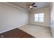 Well-lit bedroom with neutral carpet, a ceiling fan, and a window for natural light at 12926 University Cres # 2C, Carmel, IN 46032