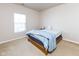 This is a bedroom with neutral walls and carpet. A single window allows for natural light to fill the space at 12926 University Cres # 2C, Carmel, IN 46032