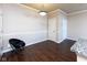 Well-lit dining area with wood-look floors, a modern light fixture, and a sleek black chair at 12926 University Cres # 2C, Carmel, IN 46032