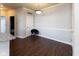 Dining area features wood-look floors, a modern light fixture, and a gray accent chair at 12926 University Cres # 2C, Carmel, IN 46032