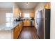 Modern kitchen with wood cabinets, granite countertops, and stainless steel appliances at 12926 University Cres # 2C, Carmel, IN 46032