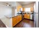 Stylish kitchen features wood cabinets, granite countertops, and stainless steel appliances at 12926 University Cres # 2C, Carmel, IN 46032
