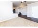 Cozy living room with neutral carpet and wood-look flooring next to a breakfast bar area at 12926 University Cres # 2C, Carmel, IN 46032