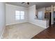 Spacious living room with carpet and wood-look flooring, ceiling fan, and a breakfast bar at 12926 University Cres # 2C, Carmel, IN 46032