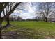 Scenic park view with lush green grass, mature trees, and a charming gazebo in the distance at 12926 University Cres # 2C, Carmel, IN 46032