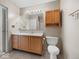 Standard bathroom featuring a wood vanity, white countertop, large mirror, and combination shower and tub at 1321 Savannah Blvd, Shelbyville, IN 46176