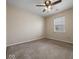 Standard carpeted bedroom with a ceiling fan, window, and neutral colored walls at 1321 Savannah Blvd, Shelbyville, IN 46176