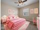 Charming pink bedroom featuring a comfortable bed, vanity, and artwork on the walls at 1321 Savannah Blvd, Shelbyville, IN 46176
