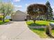 Charming single-story home featuring a well-maintained lawn and a two-car garage at 1321 Savannah Blvd, Shelbyville, IN 46176