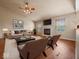 Bright living room with a vaulted ceiling, fireplace, and hardwood floors at 1321 Savannah Blvd, Shelbyville, IN 46176