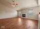 Bright and airy living room with a fireplace, ceiling fan, and beautiful hardwood floors at 1321 Savannah Blvd, Shelbyville, IN 46176