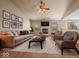 Cozy living room with a fireplace, plush seating, and stylish decor at 1321 Savannah Blvd, Shelbyville, IN 46176