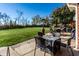 Backyard showing a large well-manicured lawn with patio seating, grill and autumn trees at 1513 Tottenham Dr, Danville, IN 46122